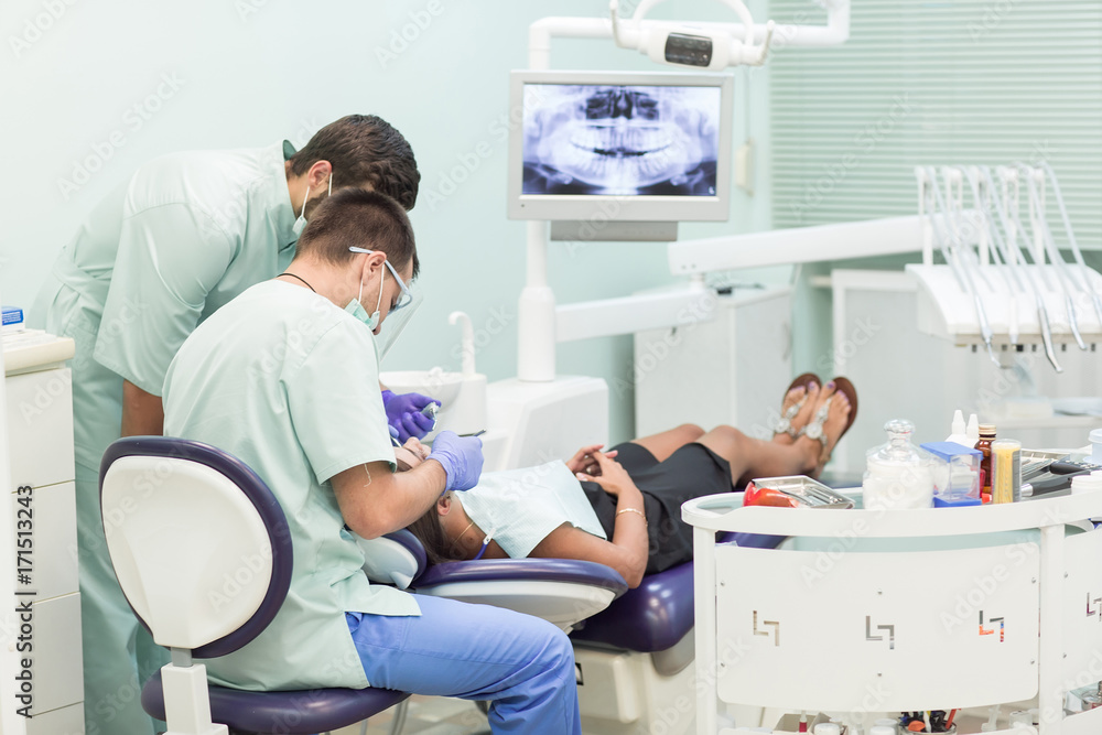 Fototapeta premium Doctor Dentist with an assistant work in a dental clinic.