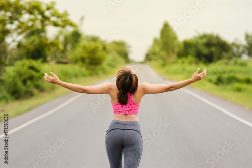 Young girl doing yoga on road Concept of healthy lifestyle and relaxation.