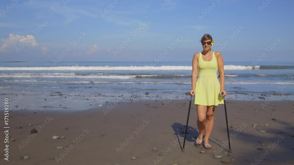 CLOSE UP: Carefree strong independent woman traveling with crutches on