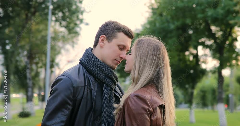 young beautiful couple hugging and kissing in the park young beautiful couple hugging and kissing in the park