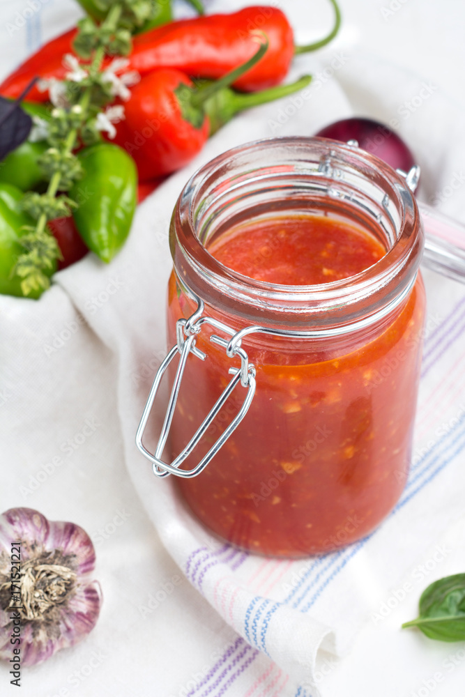 tomato sauce for pasta, pepper, basil and red onion close-up on white background. tomato sauce for pasta, pepper, basil and red onion close-up on white background.