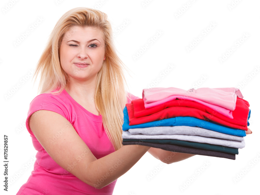 Woman holding pile of folded clothes Woman holding pile of folded clothes