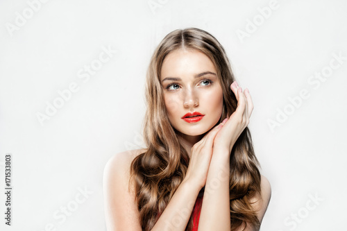 Beautiful Young Woman with Fresh Skin, Makeup and Long Curly Hair. Beauty, Facial Treatment and Cosmetology