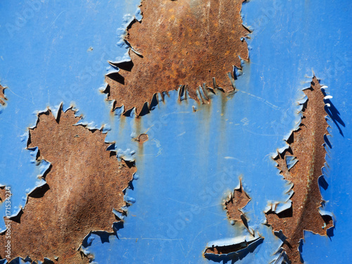 Rusty sheet with blue remnants of paint photo