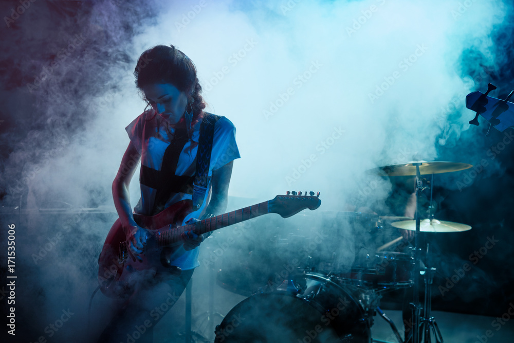 Girl-guitar player plays solo. Girl-guitar player plays solo.