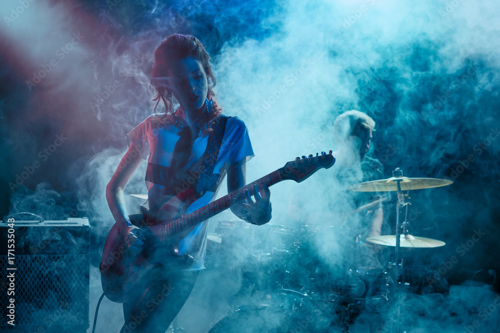 Fototapeta premium Girl-guitar player plays solo.