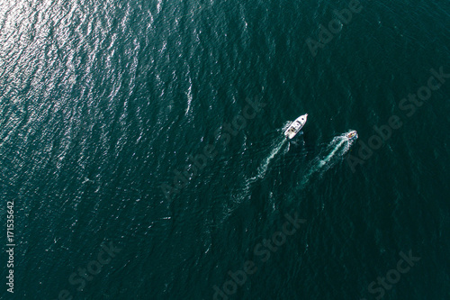 Top view of motorboats in blue, transparent waters