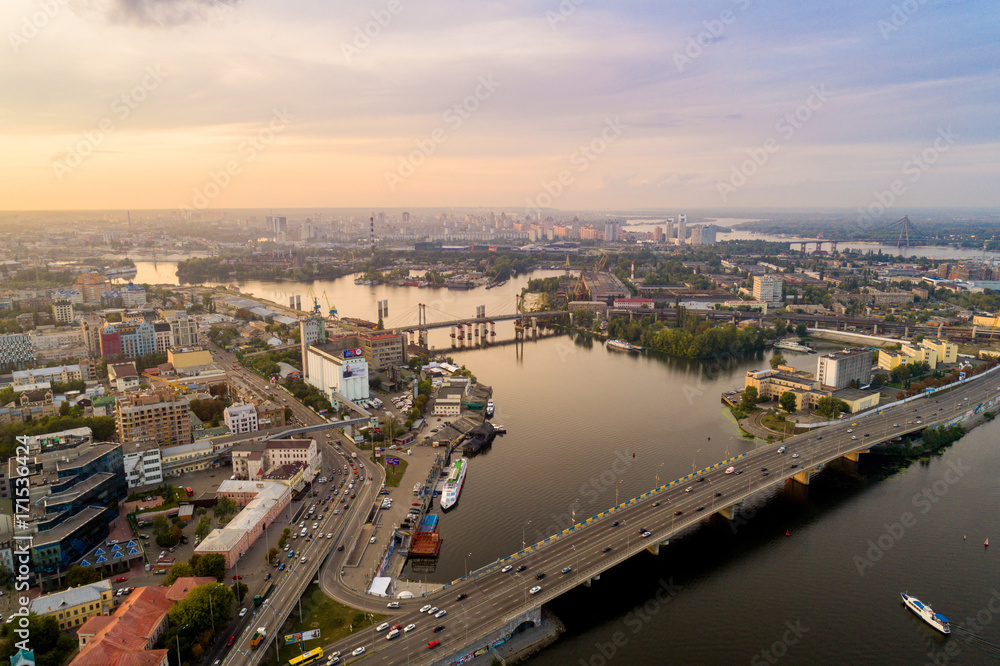 Panoramic aerial view of the old part of the city - Podol district. View of the Rybalsky Island at sunset.