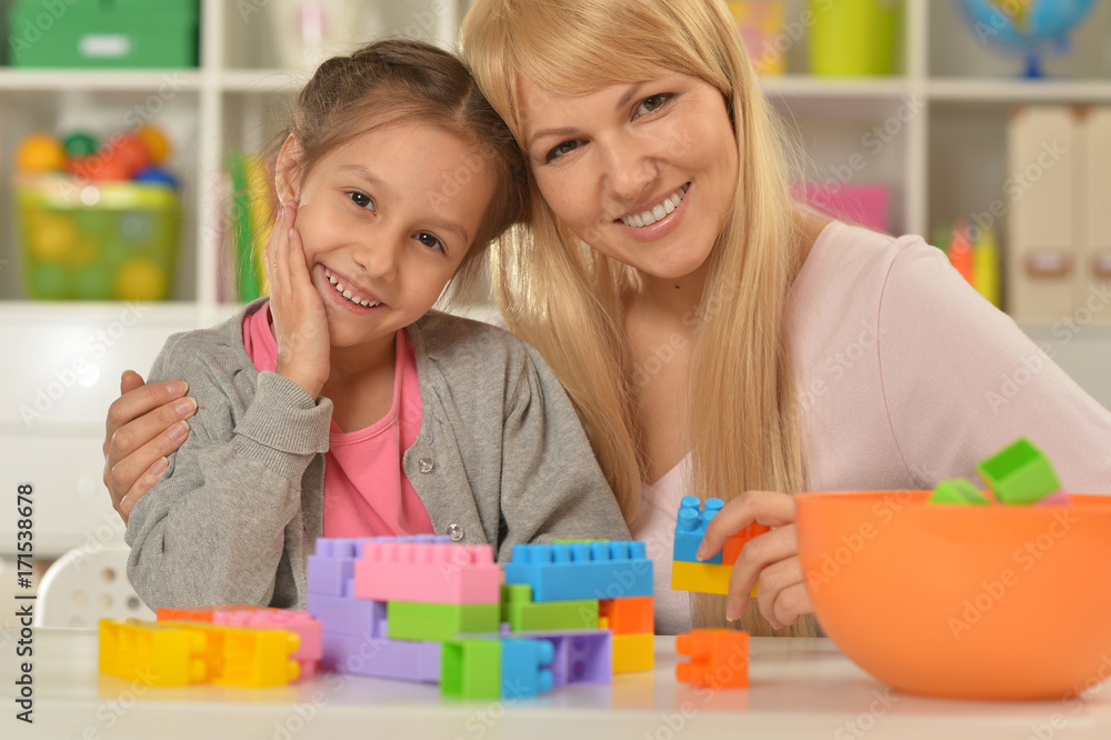 mother and daughter collecting blocks mother and daughter collecting blocks