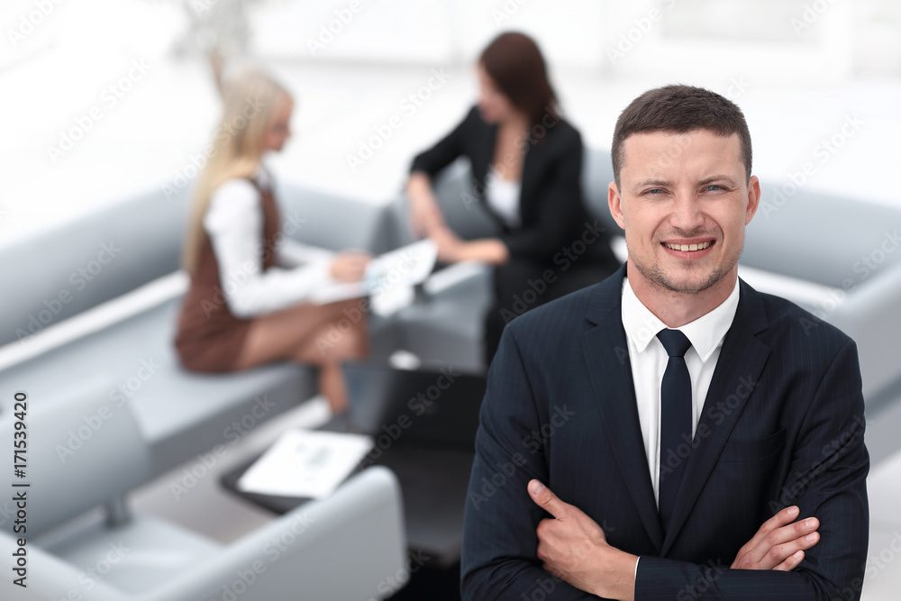 young businessman on blurred background office. young businessman on blurred background office.