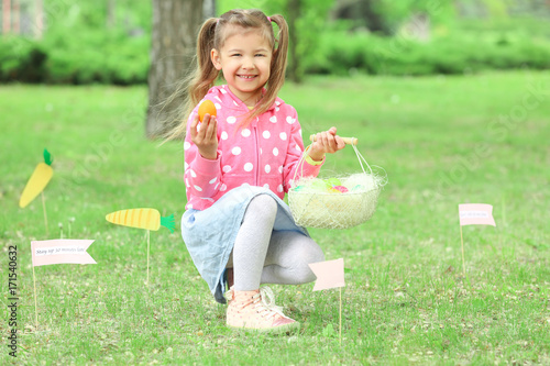 Cute little girl with baske...