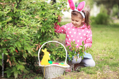 Cute little girl with baske...
