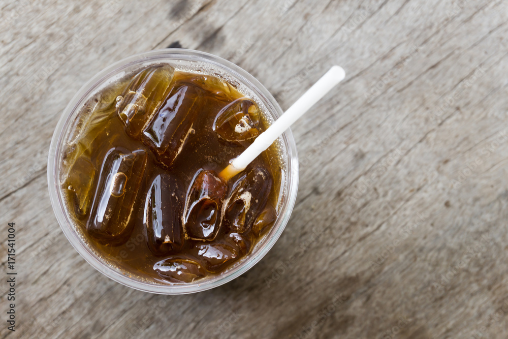 Fototapeta premium Close up ice of americano or black coffee on wood background