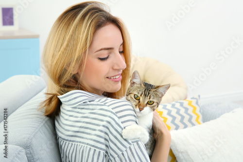 Young beautiful woman with cat at home