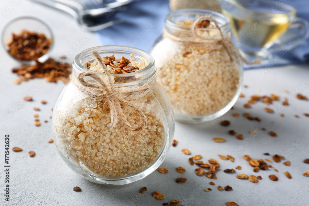 Composition with cooked quinoa and granola on grey background Composition with cooked quinoa and granola on grey background