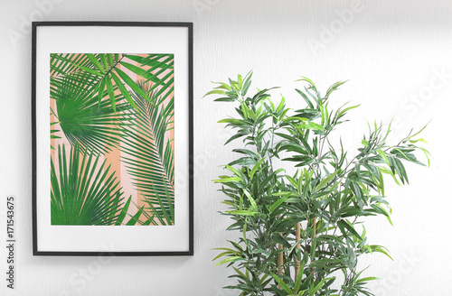 Framed picture of tropical leaves and houseplant indoors