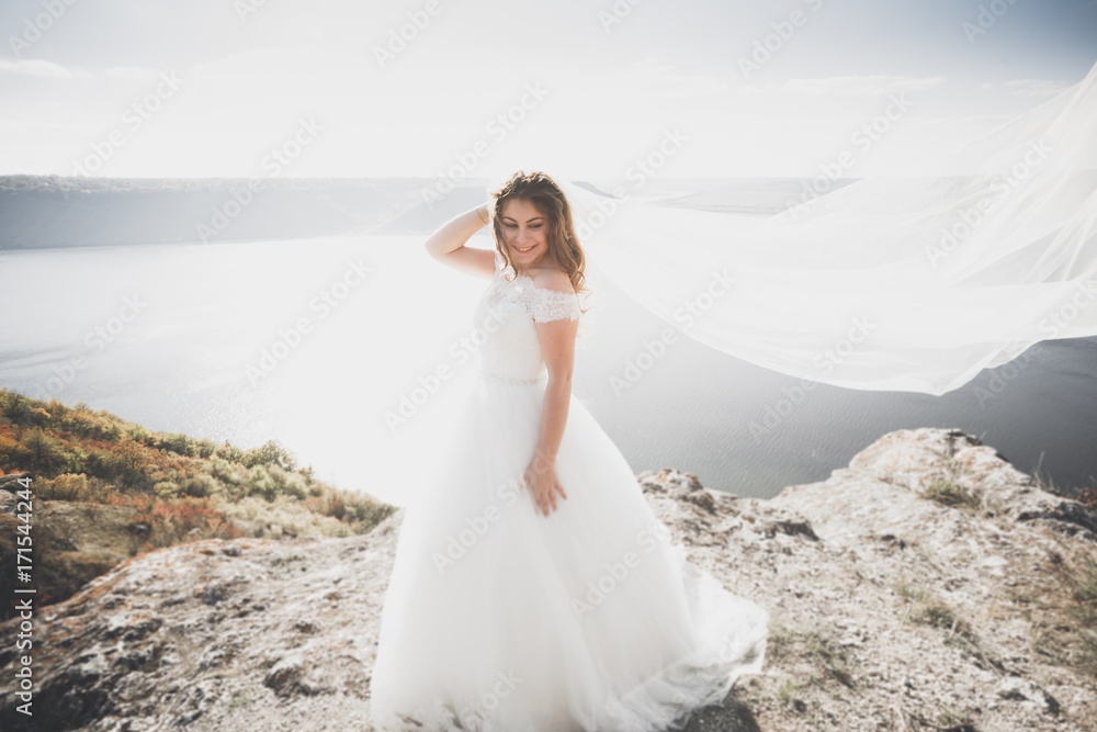 Beautiful young bride posing on the background sea