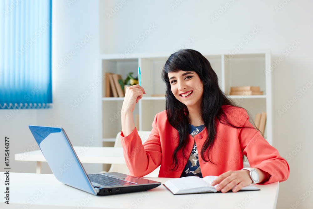 Portrait of beautiful business woman working at her desk with laptop. Portrait of beautiful business woman working at her desk with laptop.