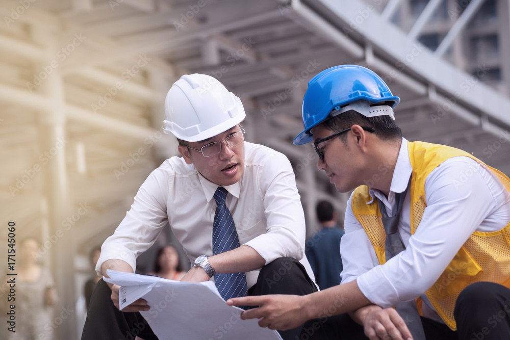 professional male and business engineers working and discuss with blueprint business together as teamwork professional male and business engineers working and discuss with blueprint business together as teamwork