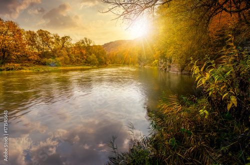 Obraz na plátne forest river in autumn mountains at sunset
