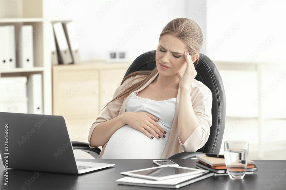 Young pregnant woman having headache in home office Young pregnant woman having headache in home office