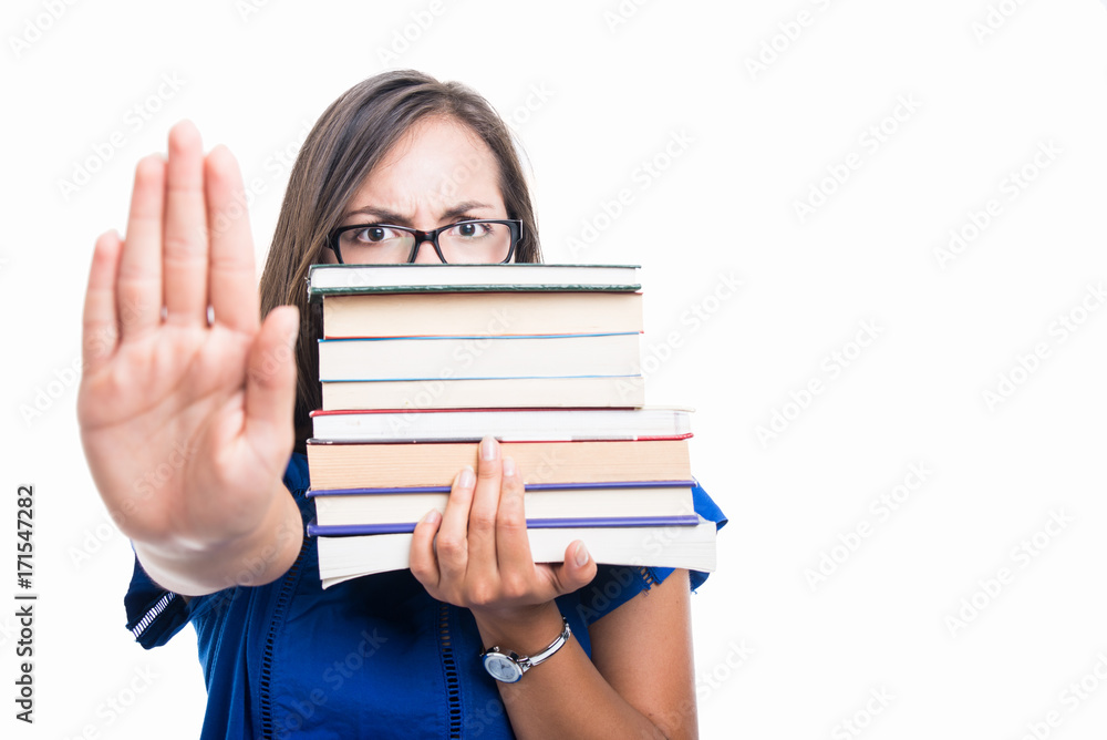 Student girl holding books showing stop covering face Student girl holding books showing stop covering face