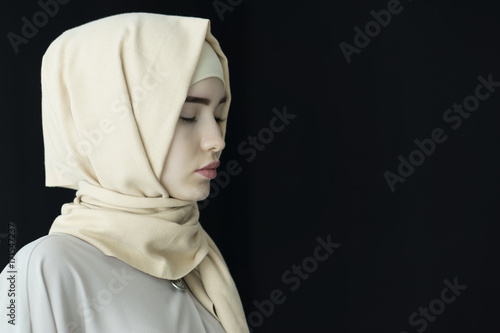 Portrait of a beautiful Muslim woman wearing hijab, isolated