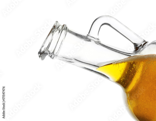 Pitcher with cooking oil on white background, closeup