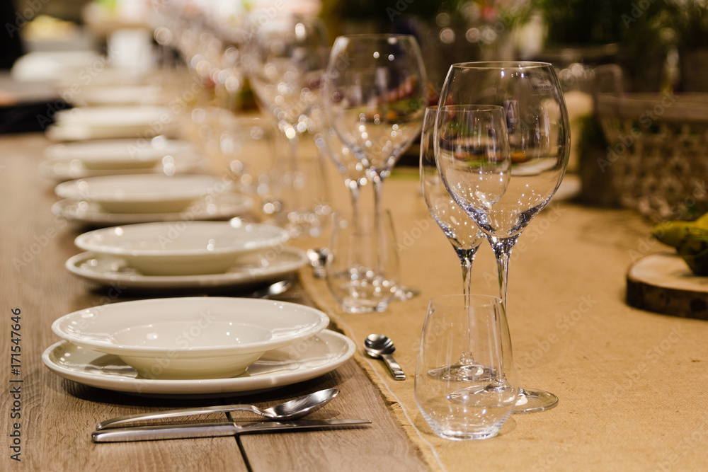 Table setting decor with cutlery, plates and glasses