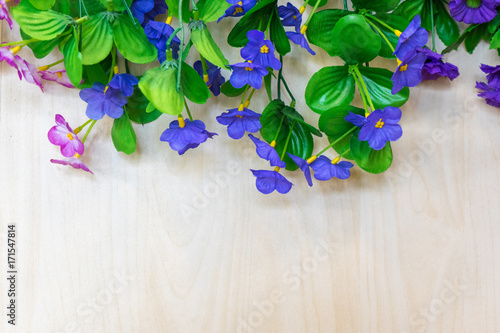 Artificial or fake flower bouquet on wood background