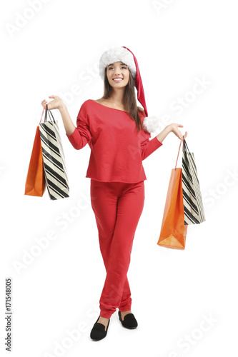 Young woman in Santa hat ho...