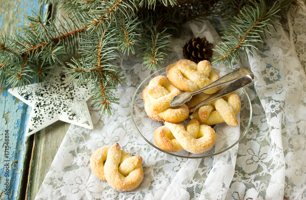 Pretzel with sugar in a New Year or Christmas decoration. Rustic style, selective focus.