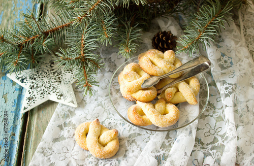 Obraz na płótnie Pretzel with sugar in a New Year or Christmas decoration. Rustic style, selective focus. w salonie