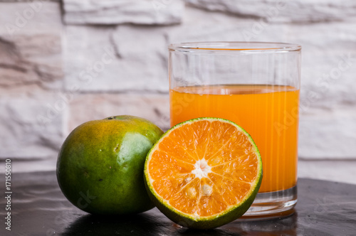 Fototapeta Naklejka Na Ścianę i Meble -  a glass of freshly squeezed tangerine juice