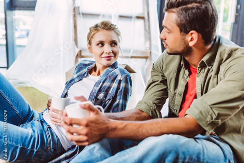 couple drinking tea in new apartment