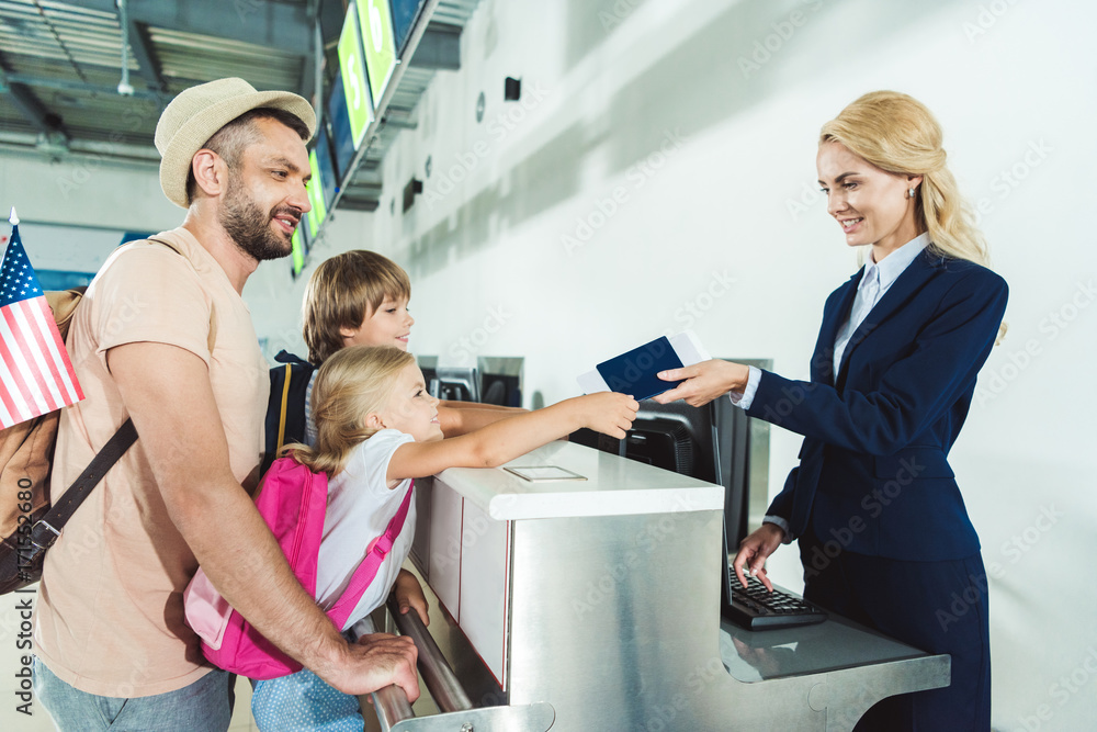 family at check in desk at airport family at check in desk at airport