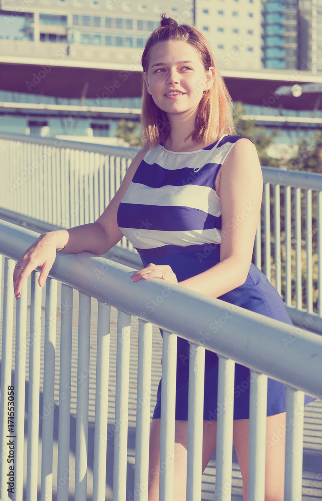 Girl posing on city bridge in summer day