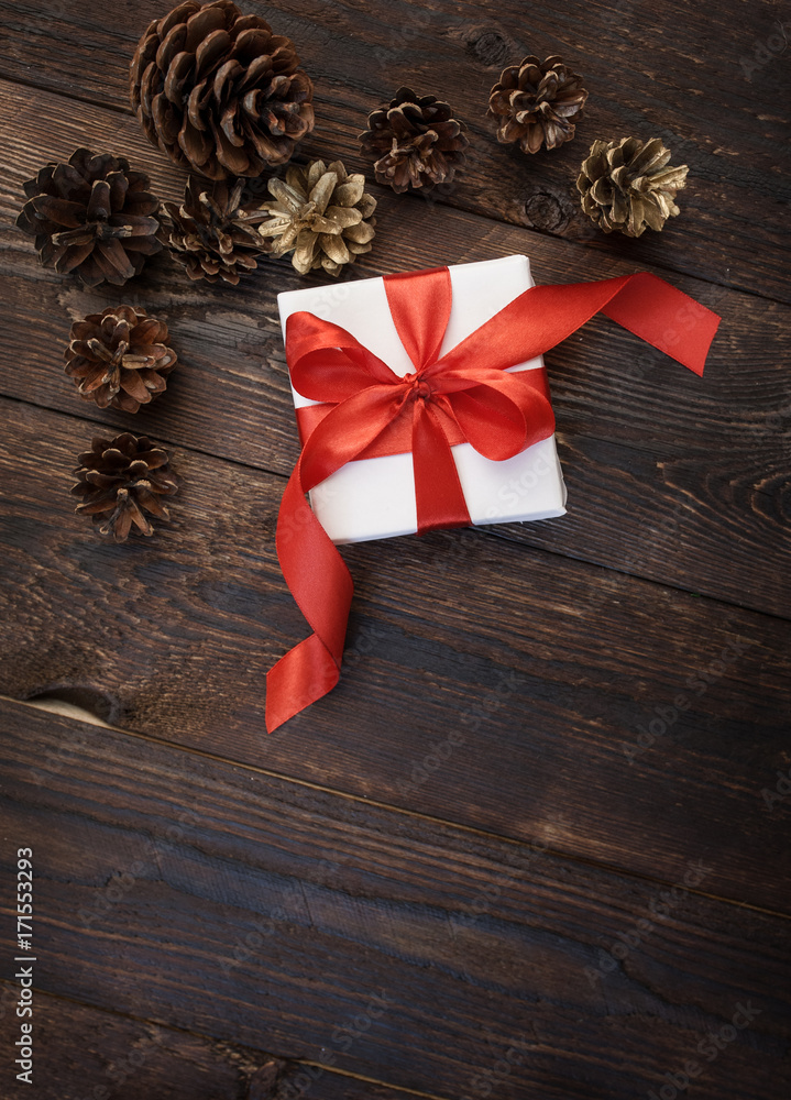 gift box with red ribbon on a wooden background gift box with red ribbon on a wooden background