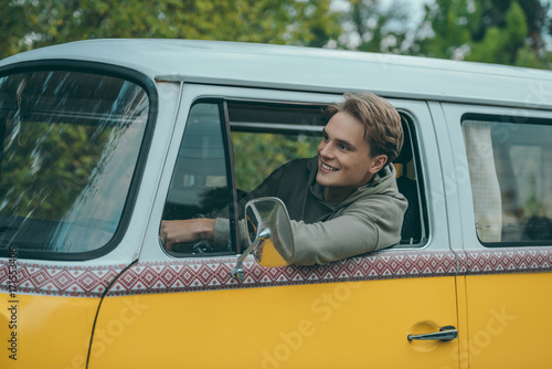 man driving retro minivan