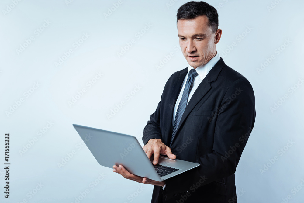 Mature entrepreneur using laptop over background Mature entrepreneur using laptop over background
