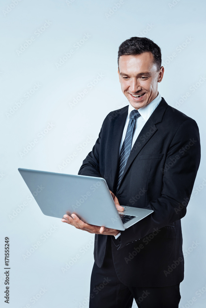 Radiant male in suit surfing internet on computer Radiant male in suit surfing internet on computer