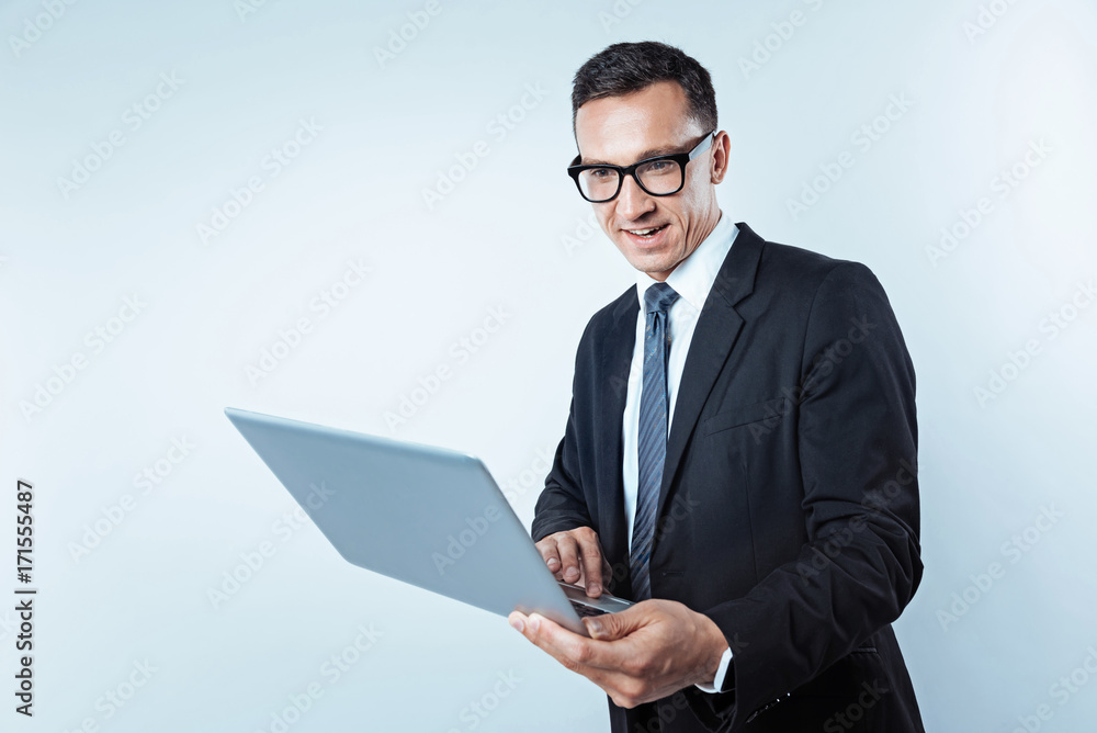 Interested mature man in suit looking at laptop Interested mature man in suit looking at laptop