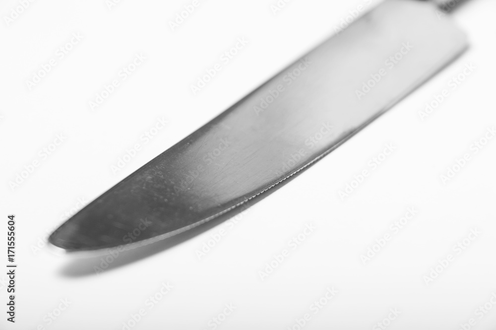 A single butter knife on a white background showing blade detail A single butter knife on a white background showing blade detail