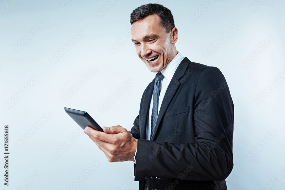 Radiant man of business using tablet computer Radiant man of business using tablet computer