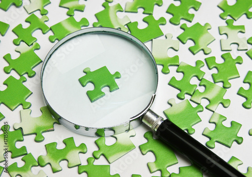 magnifying glass on the green puzzle photo