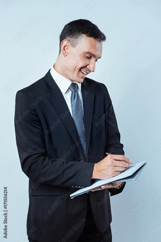 Successful businessman taking notes over background Successful businessman taking notes over background