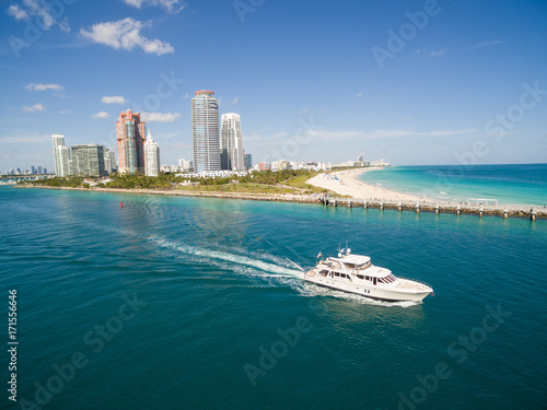 Aerial view of South Miami Beach with boat sailing next to the city line