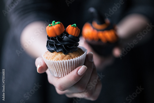 halloween cupcake in hand