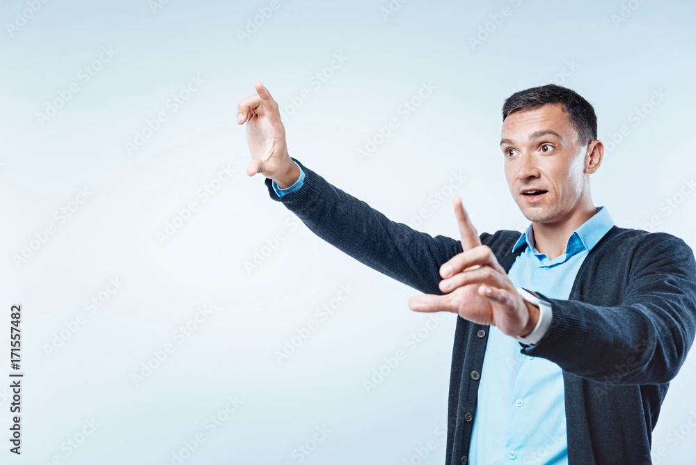 Surprised man touching transparent screen Surprised man touching transparent screen