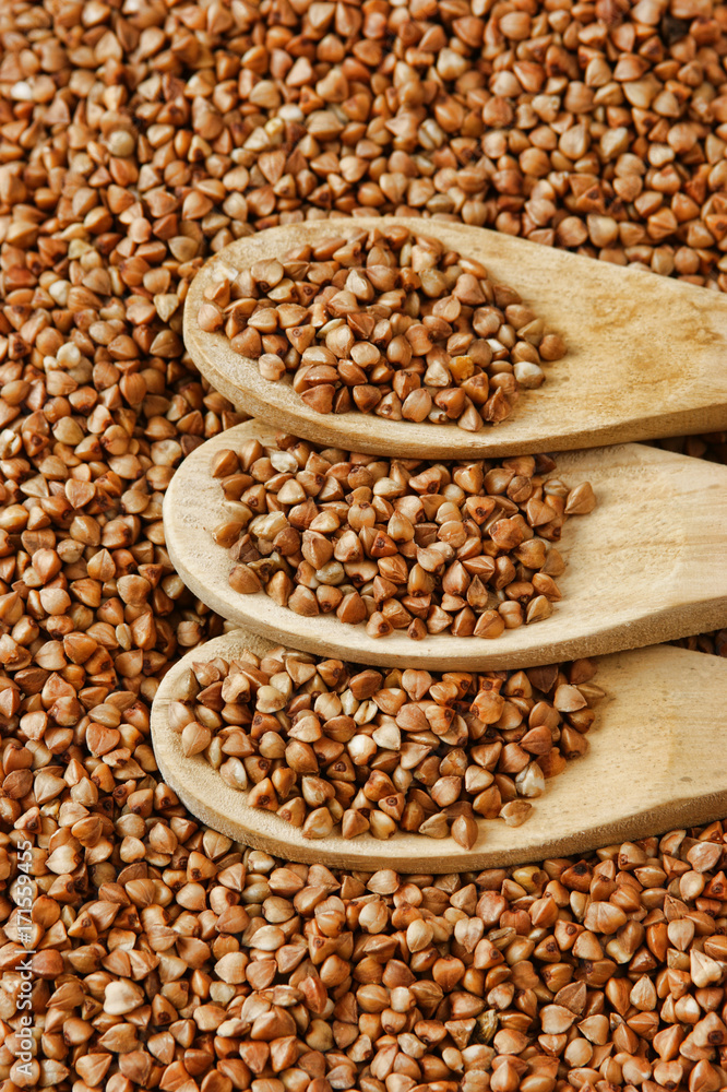 buckwheat groats and wooden spoon buckwheat groats and wooden spoon